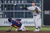Oakland Athletics second baseman Zack Gelof, left, turns a double play over Houston Astros' Jeremy Pena (3) during the sixth inning of a baseball game Wednesday, May 15, 2024, in Houston. (AP Photo/Michael Wyke)