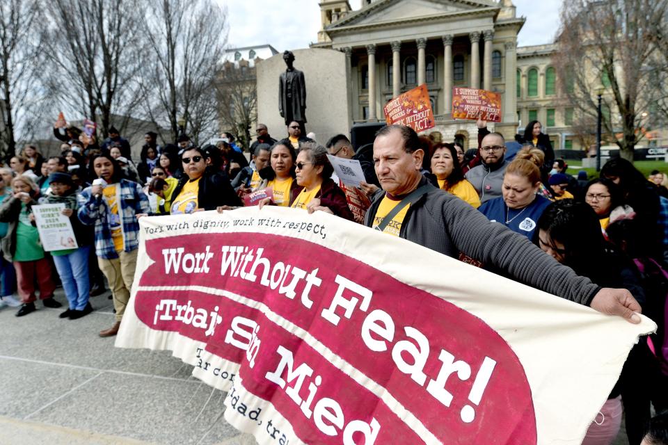 Protesters hold signs up signs during an immigration rally in front of the state Capitol Thursday, March 21, 2024, in Springfield.