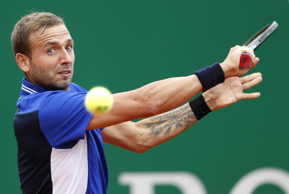 Daniel Evans of Britain returns the ball to Stefanos Tsitsipas of Greece during their semifinal match of the Monte Carlo Tennis Masters tournament in Monaco, Saturday, April 17, 2021. (AP Photo/Jean-Francois Badias)