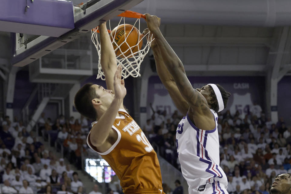 TCU forward Emanuel Miller, right, dunks in front of Texas forward Brock Cunningham (30) during the first half of an NCAA college basketball game in Fort Worth, Texas, Saturday, Feb. 3, 2024. (AP Photo/Michael Ainsworth)