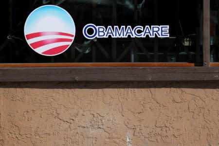 FILE PHOTO: A sign on an insurance store advertises Obamacare in San Ysidro, San Diego, California, U.S., October 26, 2017. REUTERS/Mike Blake/File Photo