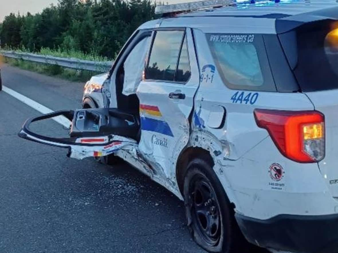 RCMP say a passing driver had to help a Mountie out of this vehicle after it was hit head-on by an SUV going the wrong way on a highway off-ramp in Tracadie, N.B., on Wednesday night. (Submitted by Tracadie RCMP - image credit)