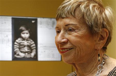 US author Sonia Pressman Fuentes from Sarasota, Florida, smiles as she stands next to a photo taken of her when she was five years old while visiting the "Millions of People, One Dream" exhibition at the Red Star Line Museum in Antwerp September 24, 2013. REUTERS/Yves Herman