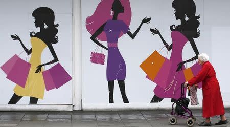 A shopper walks past an empty retail unit in Nottingham, central England, June 6, 2013. REUTERS/Darren Staples