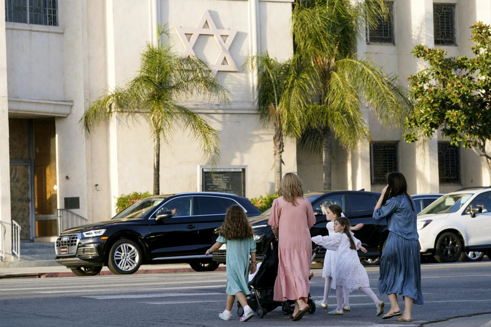 Mothers and daughters walk across the Congregation Shaarei Tefila synagogue in Los Angeles on Saturday, Oct. 7, 2023. (AP Photo/Damian Dovarganes)