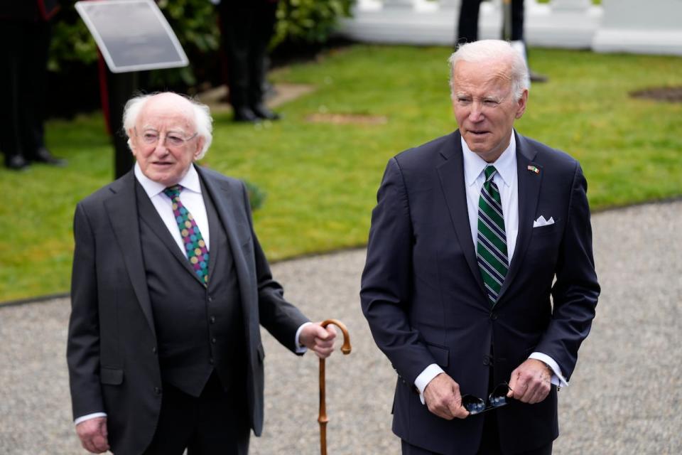 President Joe Biden walks with Irish President Michael Higgins after ringing the Peace Bell at Aras an Uachtarain, the presidential residence, on April 13, 2023 in Dublin.