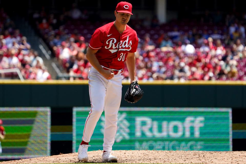 Cincinnati Reds starting pitcher Tyler Mahle (30) reacts after striking out a batter to end the top of the fifth inning during a baseball game against the San Francisco Giants, Sunday, May 29, 2022, at Great American Ball Park in Cincinnati. The San Francisco Giants won, 6-4.