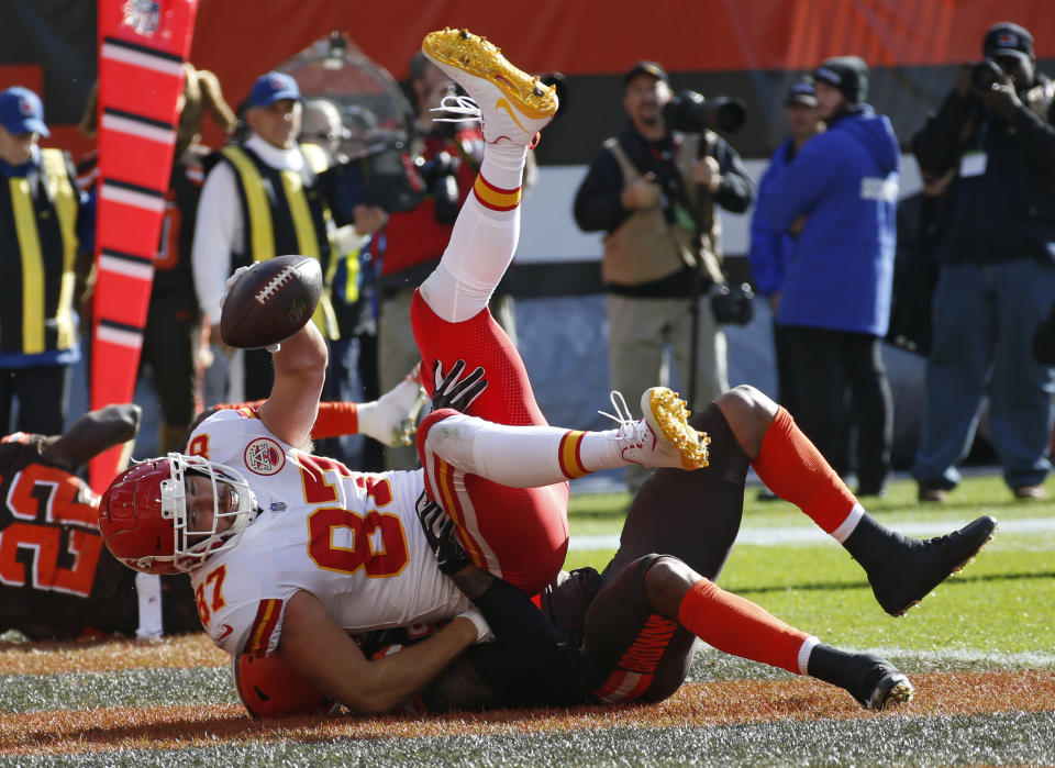 Kansas City Chiefs tight end Travis Kelce is tackled by Cleveland Browns linebacker Christian Kirksey after scoring on an 11-yard pass during the first half of an NFL football game, Sunday, Nov. 4, 2018, in Cleveland. (AP Photo/Ron Schwane)