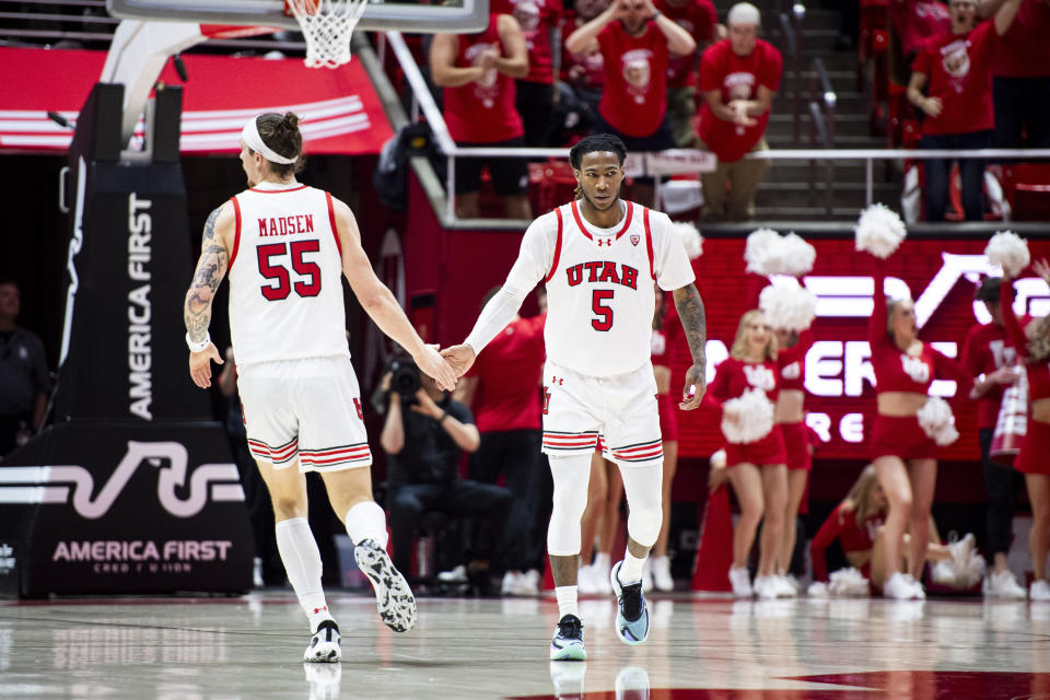 Utah guard Deivon Smith (5) slaps hands with Utah guard Gabe Madsen (55) after Smith made a three-pointer against Oregon State during the second half of an NCAA college basketball game Thursday, Jan. 18, 2024, in Salt Lake City. (AP Photo/Isaac Hale)