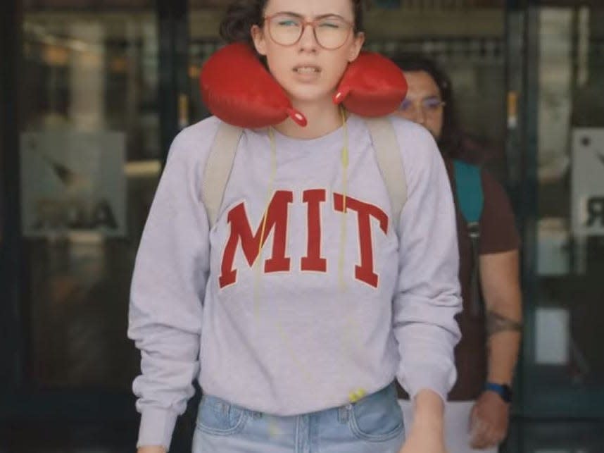 lina getting to the airport in her mit sweatshirt and neck pillow love and gelato