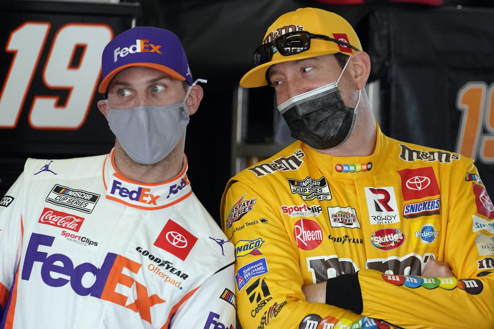 Denny Hamlin, left, and Kyle Busch joke around in the garages during a NASCAR Daytona 500 auto race practice session at Daytona International Speedway, Wednesday, Feb. 10, 2021, in Daytona Beach, Fla. (AP Photo/John Raoux)