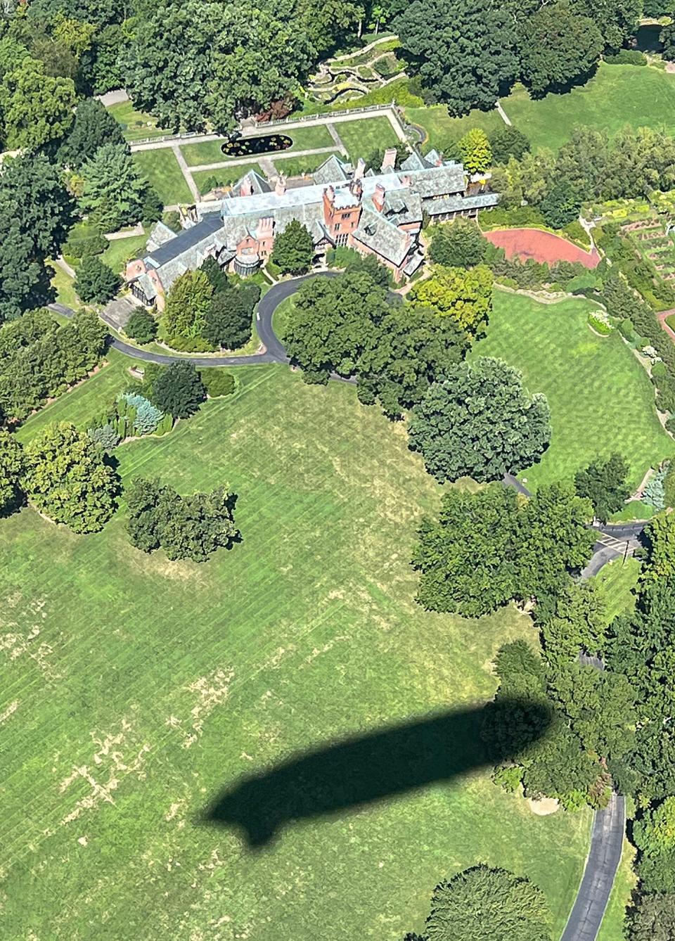 The shadow of the Goodyear blimp is cast on the Stan Hywet grounds during a tour by Akron historian Dave Lieberth on Tuesday, August 29, 2023 in Akron.