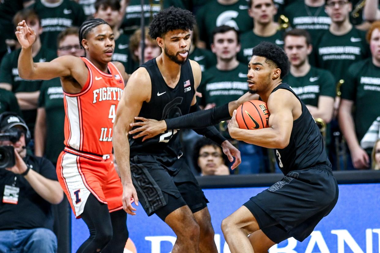 Michigan State's Jaden Akins, right, pulls a rebound next to Malik Hall, center, and Illinois' Justin Harmon, left, during the second half on Saturday, Feb. 10, 2024, at the Breslin Center in East Lansing.