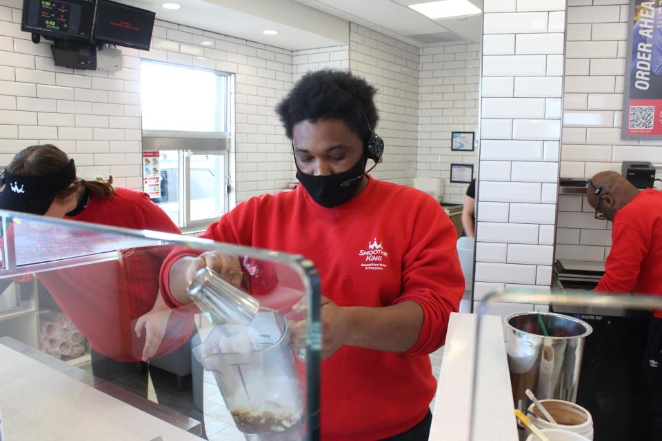 Jalen Carridine puts ice in a smoothie at the Hartland location of Smoothie King on Tuesday, Jan. 24, 2023.