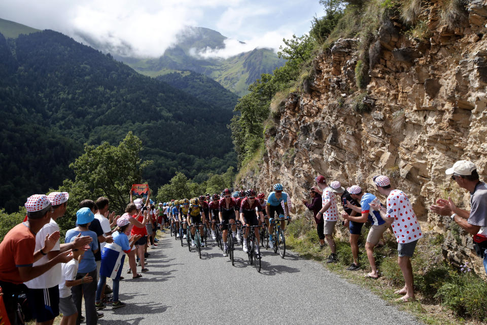 FILE - In this July 18, 2019, file photo, the pack climbs the Hourquette d'Ancizan pass during the 12th stage of the Tour de France cycling race over 209,5 kilometers (130 miles) with start in Toulouse and finish in Bagneres-de-Bigorre, France. The middle week of the three-week cycling race, which would have had its first rest day Monday after nine consecutive days of racing, would have been this week, if not for the coronavirus. The 21-stage race over 23 days will now start Aug. 29 and finish Sept. 20. (AP Photo/ Christophe Ena, File)