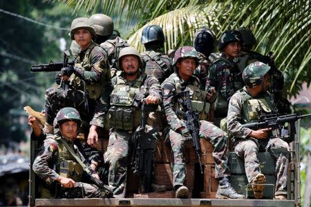 Philippines army soldiers ride in trucks into the fighting zone as government troops continue their assault against insurgents from the Maute group in Marawi City, Philippines June 28, 2017. REUTERS/Jorge Silva