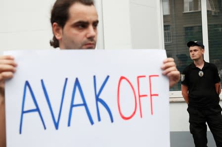 A man attends a protest outside the headquarters of Ukraine's Interior Ministry in Kiev