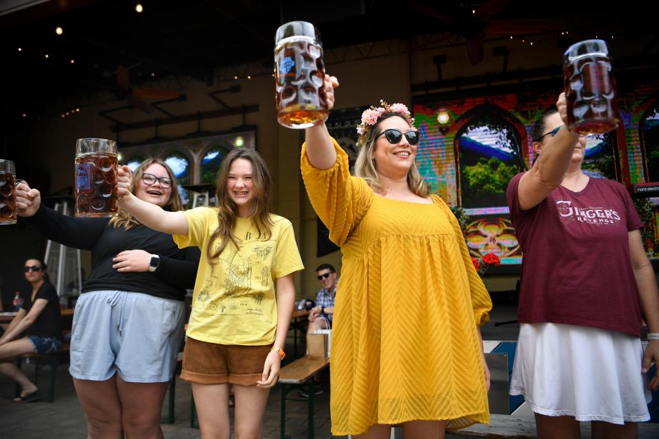 Jaimie Almada, center right, smiles while competing in a stein hoisting competition during Schulz BrÃ¤u Brewing Company's 2nd Annual Maifest on Saturday, May 13, 2023. Almada, who is visiting from Savannah, GA, earned a 3rd place finish. 