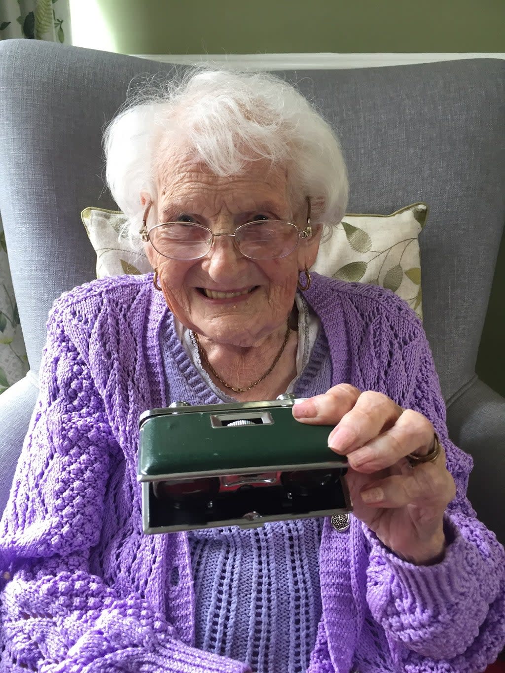 A care home resident holding a memory box (Wessex Heritage Trust/PA)