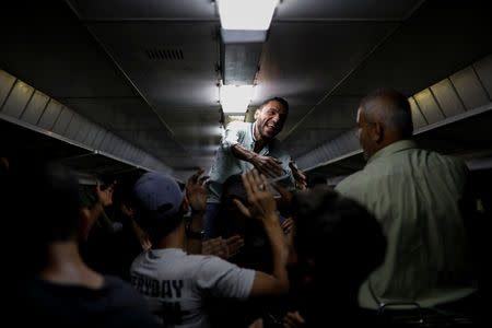 People sing in a train as they travel through the outskirts of Damascus towards recently opened international fair in Damascus, Syria, September 12, 2018. REUTERS/Marko Djurica