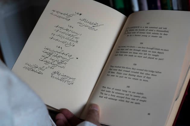 Muhammad Ali Mojaradi with a book of Persian poetry translated into English on the right side at his home in Troy, Michigan, on Sunday, March 19, 2023. Mojaradi said his PayPal account was frozen three times and that more than two dozen payments made to him were flagged over three years. 