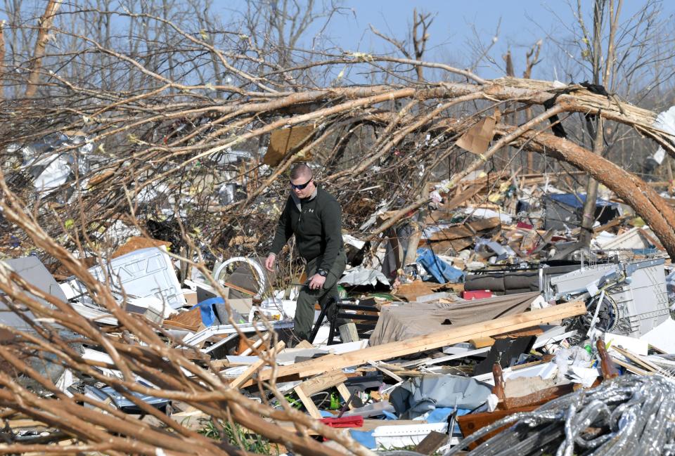 Law enforcement personnel look through debris March 4 in Cookeville, Tenn., after a tornado touched down.
