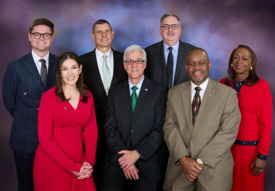 Front Row (left to right): Megan Czako Reamsnyder, Michael Heyeck, Kenneth L. Wright Back Row (left to right) : David Grimes, Jeff Washburn, Dennis Blair, Coutanya Coombs. Blair has since been replaced by Glasgow (not pictured).