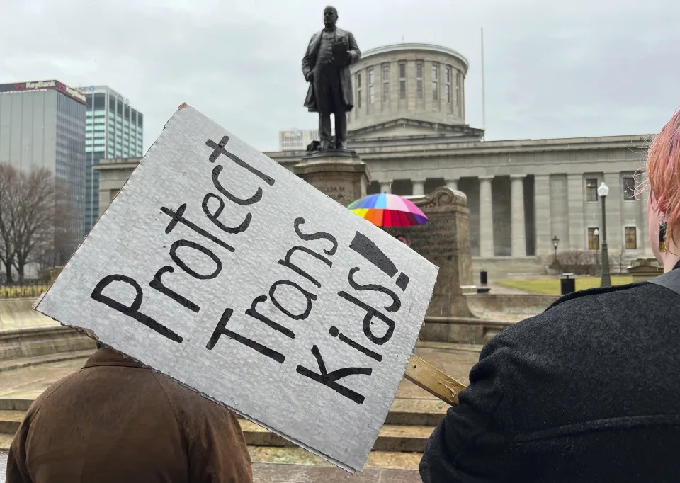 FILE - Demonstrators advocating for transgender rights and healthcare stand outside of the Ohio Statehouse on Jan. 24, 2024, in Columbus, Ohio. Republican states are filing a barrage of legal challenges against the Biden administration's newly expanded campus sexual assault rules, saying they overstep the president's authority and undermine the Title IX anti-discrimination law. (AP Photo/Patrick Orsagos, File)