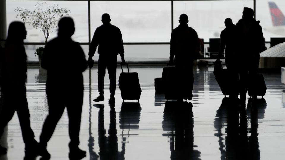 Travelers roll luggage through Salt Lake City International Airport on Feb. 22 as brutal winter weather hammered the northern U.S.  with "whiteout" snow, dangerous wind gusts and bitter cold,