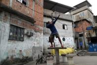 Vitor Soares, 16, who trains in the Mangueira Olympic Village, poses next to his house in Cajueiro slum in Rio de Janeiro, Brazil, August 16, 2016. REUTERS/Ricardo Moraes