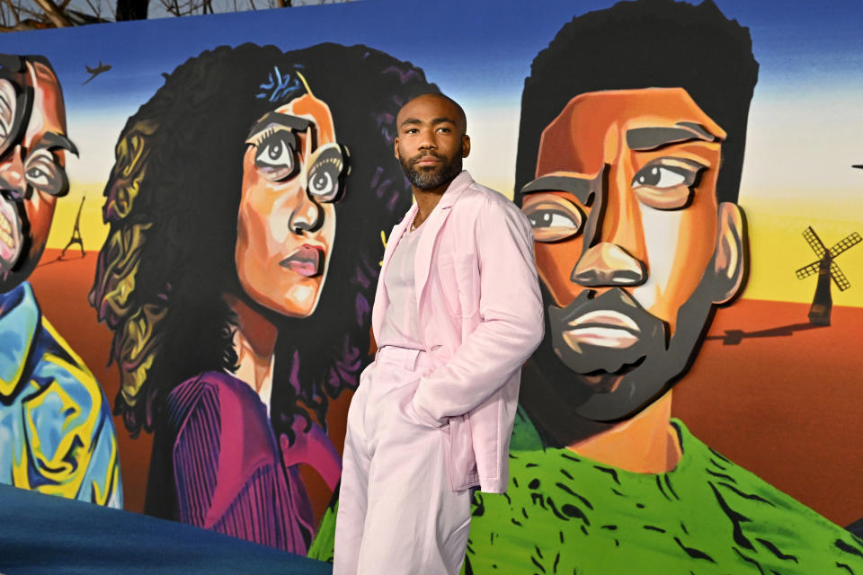 Donald Glover stands in front of the show's billboard at the Atlanta premiere in Hollywood