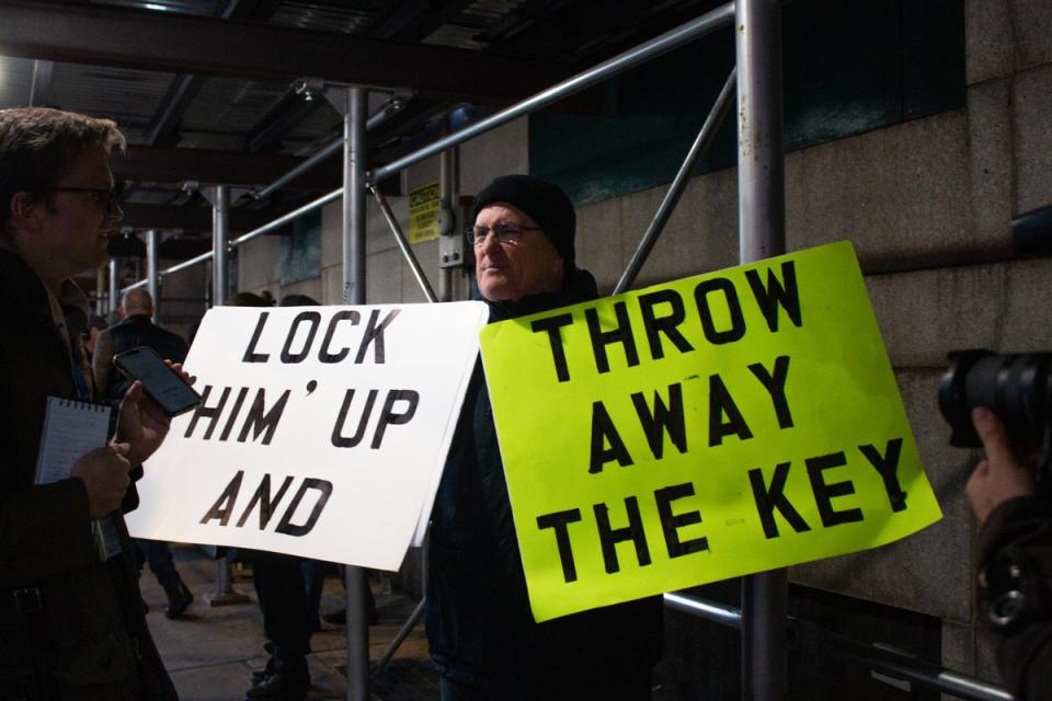 Outside of the courthouse, a protester advocates in favor of the Trump indictment (Ariana Baio / The Independent)