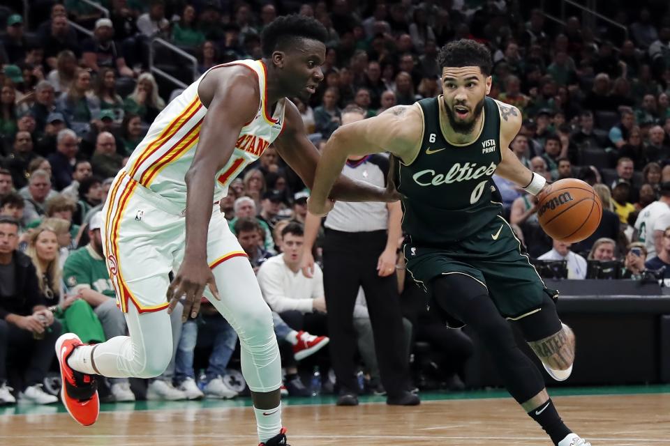 Boston Celtics' Jayson Tatum (0) drives past Atlanta Hawks' Clint Capela in the second half during Game 1 in the first round of the NBA basketball playoffs, Saturday, April 15, 2023, in Boston. (AP Photo/Michael Dwyer)