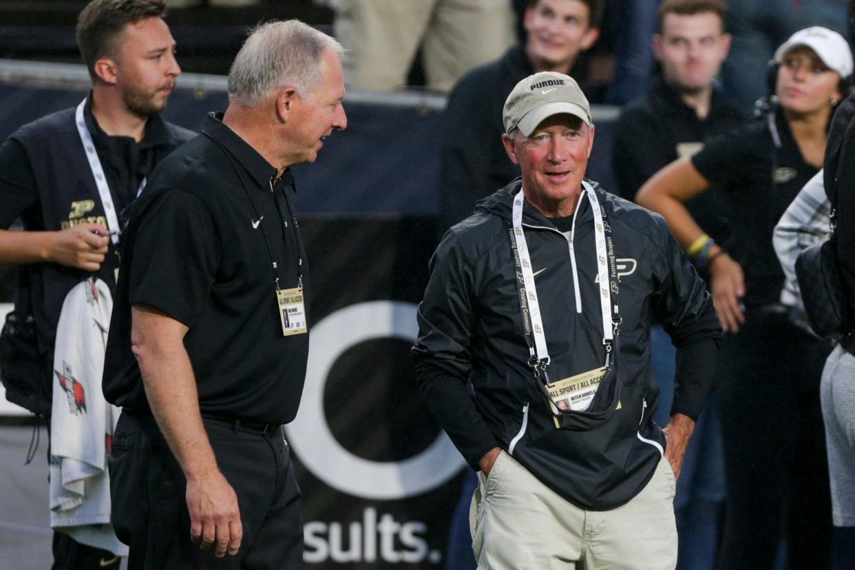 Purdue President Mitch Daniels, right, and athletic director Mike Bobinski talk during the first quarter of an NCAA college football game, Saturday, Sept. 4, 2021 at Ross-Ade Stadium in West Lafayette.