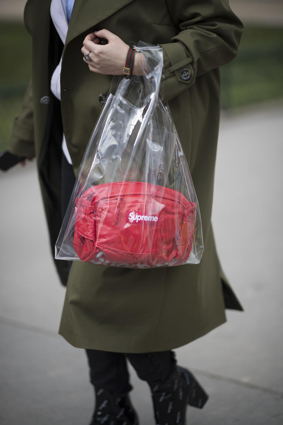 <p>Model carries red Supreme bag inside clear plastic tote. (Photo: Getty Images) </p>