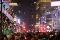 Fans stand on a transit vehicle as thousands of fellow supporters celebrate in the streets after the Toronto Raptors defeated the Golden State Warriors during Game 6 NBA Finals to win the NBA Championship, in Toronto on Friday, June 14, 2019. (Tijana Martin/The Canadian Press via AP)