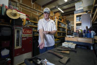 Movie prop master Scott Reeder demonstrates a retractable stunt syringe and needle prop at his shop in Austin, Texas, on April 26, 2021. Reeder's TikTok video about prop retractable needles was used without his permission to spread false claims about politicians getting fake vaccinations. Individuals across the country, like Reeder, have found themselves swept into the misinformation maelstrom, their online posts or their very identities hijacked by anti-vaccine activists and others peddling lies about the COVID-19 outbreak. (AP Photo/Eric Gay)