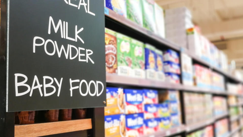 Cereal, milk powder, baby food signage grocery categoy aisle at supermarket.