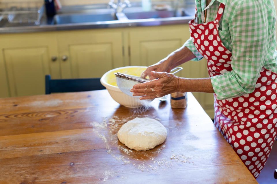 A woman kneading dough