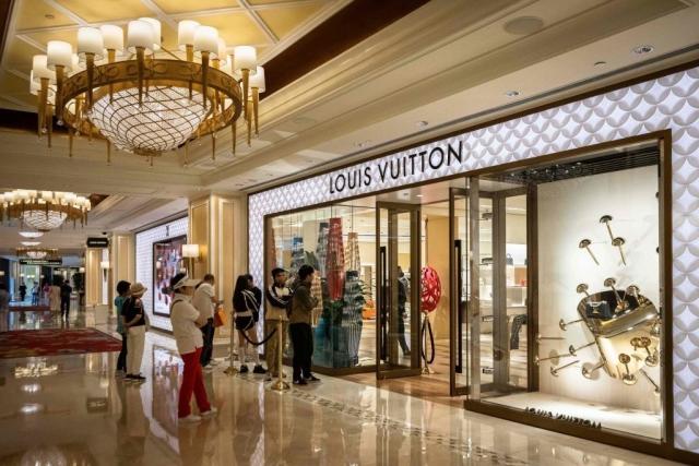 Women shoppers walk past a Louis Vuitton store at the Dubai Mall News  Photo - Getty Images