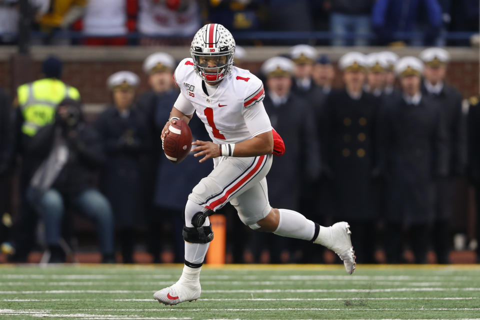 Ohio State quarterback Justin Fields rolls out to pass against Michigan in 2019. (AP Photo/Paul Sancya)