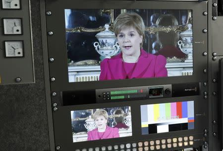 Scotland's First Minister Nicola Sturgeon is seen on screens in a television production truck as she demands a new independence referendum to be held in late 2018 or early 2019, once the terms of Britain's exit from the European Union have become clearer, outside Bute House, in Edinburgh, Scotland, Britain March 13, 2017. REUTERS/Russell Cheyne