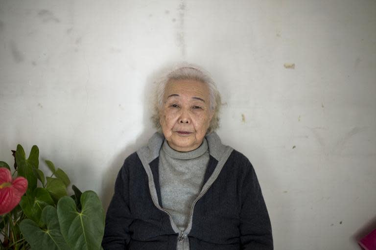 Li Fengqin, whose father was a victim at Unit 731, poses for a photograph at her home in China's Jilin province