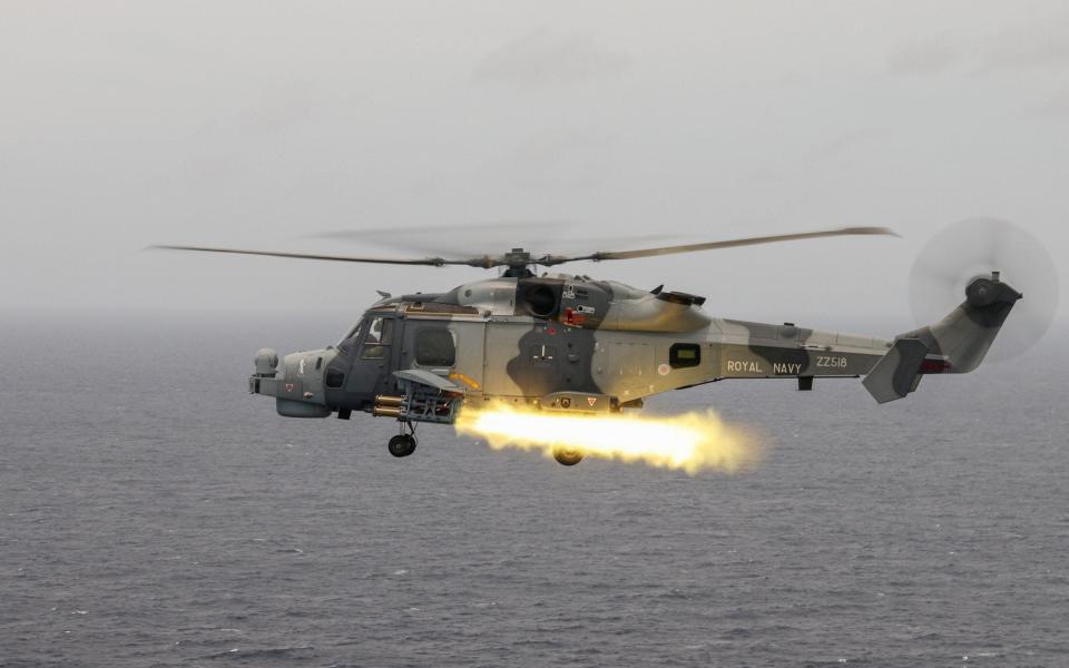 HMS Defender&#39;s Wildcat helicopter from 815 Naval Air Squadron firing the Martlet lightweight missile during operations in the Pacific Ocean - Ministry of Defence/PA