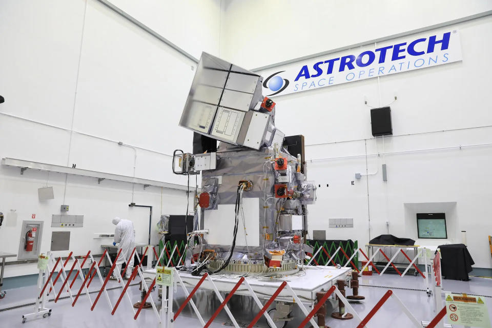 Technicians work to process NASA’s Plankton, Aerosol, Cloud, ocean Ecosystem (PACE) observatory in a bay at the Astrotech Space Operations Facility near the agency’s Kennedy Space Center in Florida on Monday, Dec. 4, 2023.