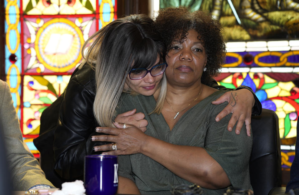 Cheyenna Beauford, left, hugs her mother, Tiffany Marsh, before Marsh speaks at a news conference, Monday, May 1, 2023, in downtown Denver, over a settlement reached in the death of Marsh's son while in police custody nearly a decade earlier, in Mesa County, Colo. Mesa County paid $1.6 million and a private health contractor paid $400,000 to settle the case, which stems from a civil rights violation in 2014. (AP Photo/David Zalubowski)