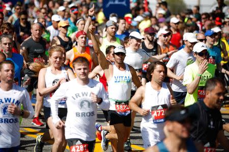 Apr 17, 2017; Hopkinton, MA, USA; Steve Cortes of Jensen Beach, FL puts up his hand as he crosses the start line at the 2017 Boston Marathon. Paul Rutherford-USA TODAY Sports