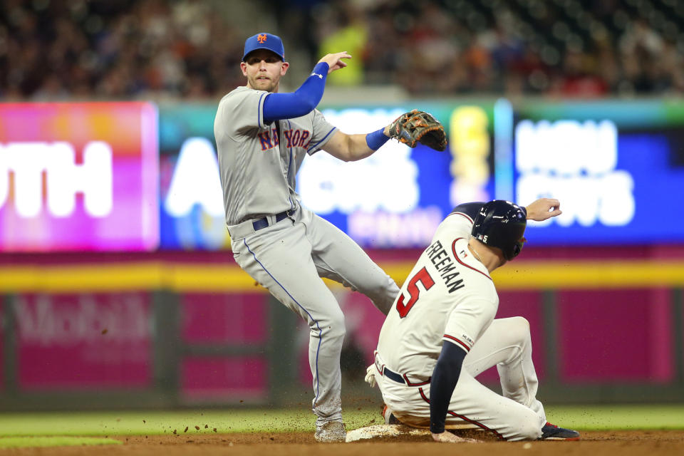 Aug 13, 2019; Atlanta, GA, USA; New York Mets second baseman Jeff McNeil (6) turns a double play over Atlanta Braves first baseman Freddie Freeman (5) in the fourth inning at SunTrust Park. Mandatory Credit: Brett Davis-USA TODAY Sports