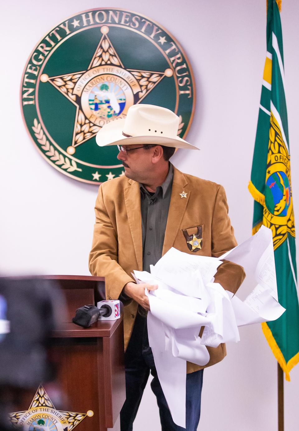 Marion County Sheriff Billy Woods holds Kendra Boone’s rap sheet during his Friday press conference.