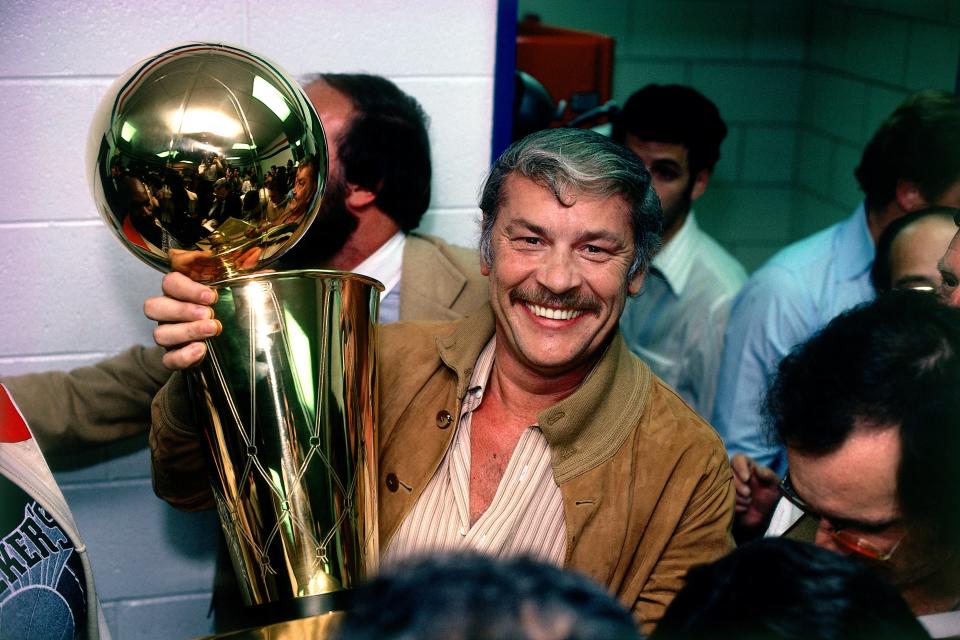 Los Angeles Lakers owner Jerry Buss poses with the NBA Championship trophy in 1980. (Photo by Rich Pilling/NBAE via Getty Images)